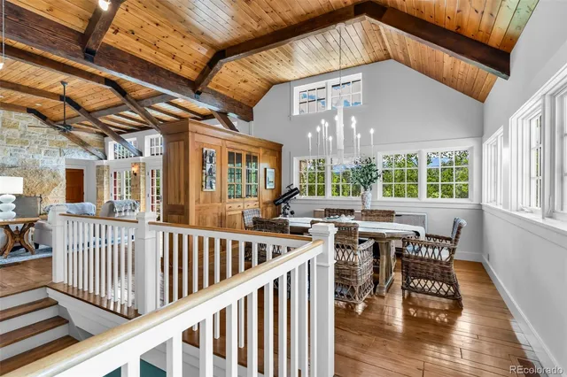 a view of a house with a deck and furniture