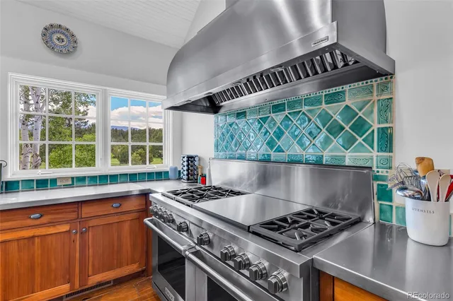 a kitchen with granite countertop a stove and a sink