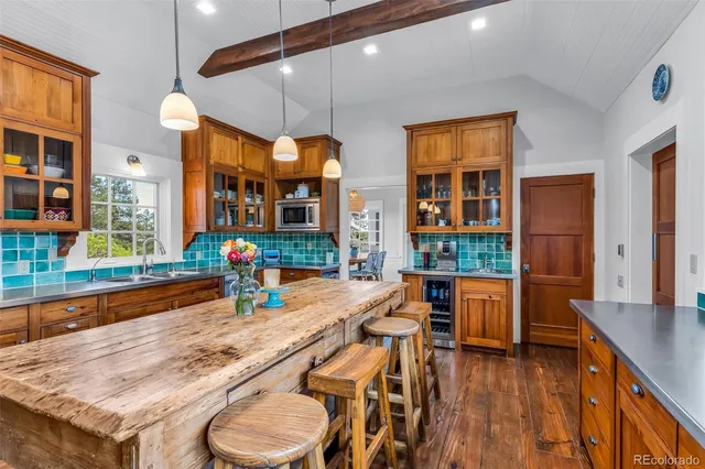 a dining room with stainless steel appliances granite countertop a stove and kitchen view with wooden floor
