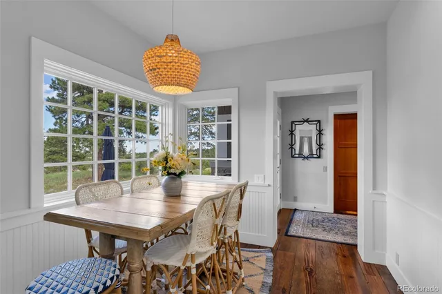 a dining room with furniture and wooden floor