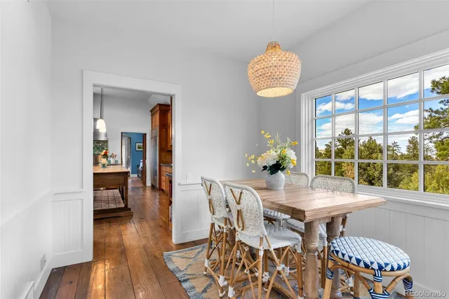 a dining room with furniture and wooden floor