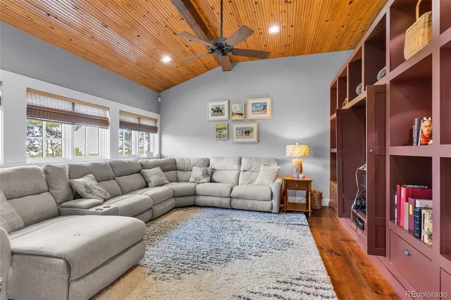 a living room with furniture and a book shelf