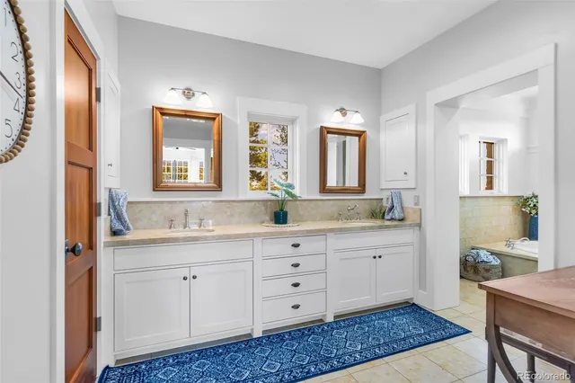a spacious bathroom with a granite countertop sink a mirror and a