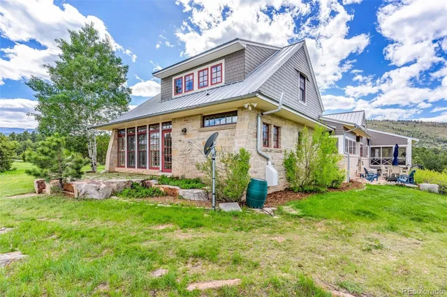 a view of a house with a yard porch and sitting area
