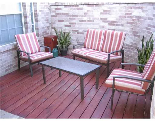 a balcony with wooden floor outdoor seating