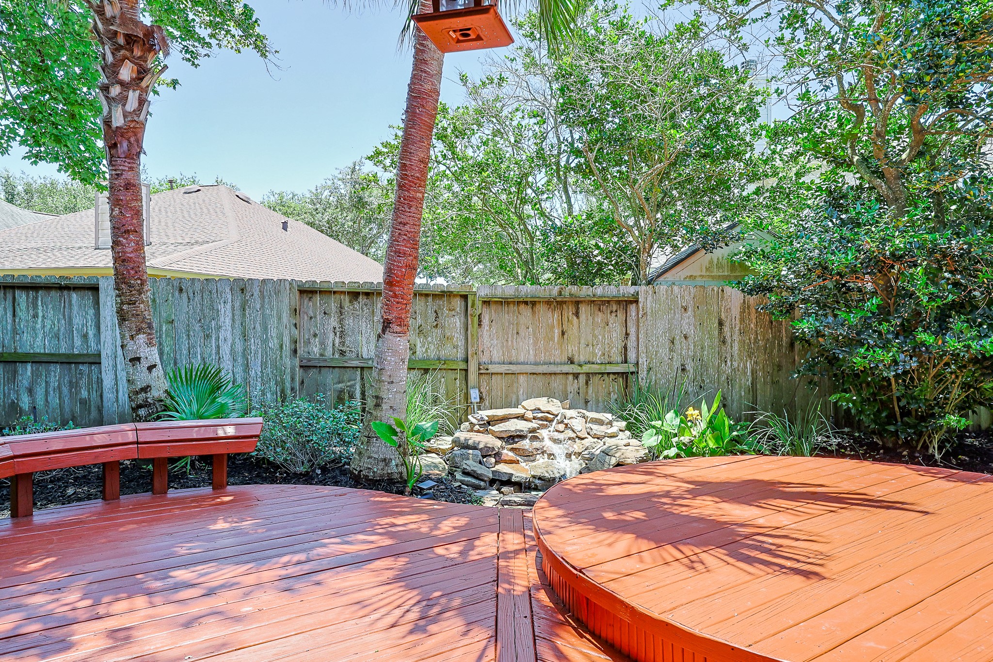 10306 Rudolph Court Missouri City, TX 77459 - Photo 27 of 34 Anchored by a gorgeous natural stone rock waterfall feature that brings the soothing sound of flowing water to your outdoor space.