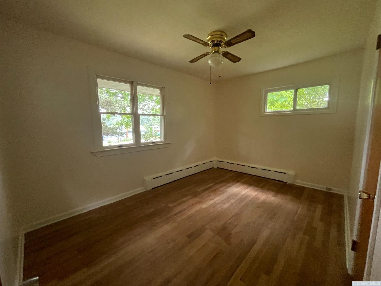 14 Cairo Junction Road Catskill, NY 12451 - Photo 15 of 25 a view of an empty room with wooden floor and a window