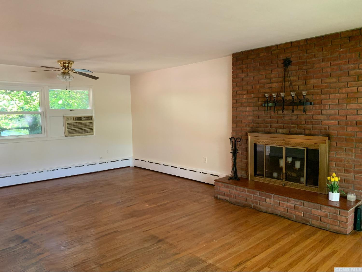 14 Cairo Junction Road Catskill, NY 12451 - Photo 4 of 25 a view of an empty room with a fireplace and a window