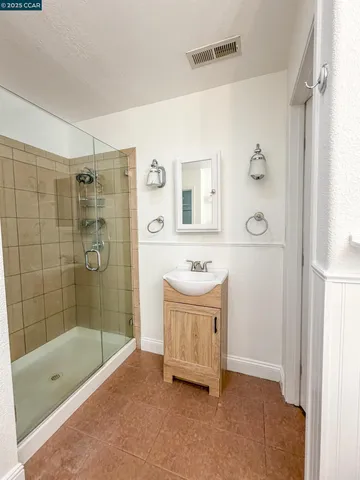 a bathroom with a tub sink a shower and a mirror