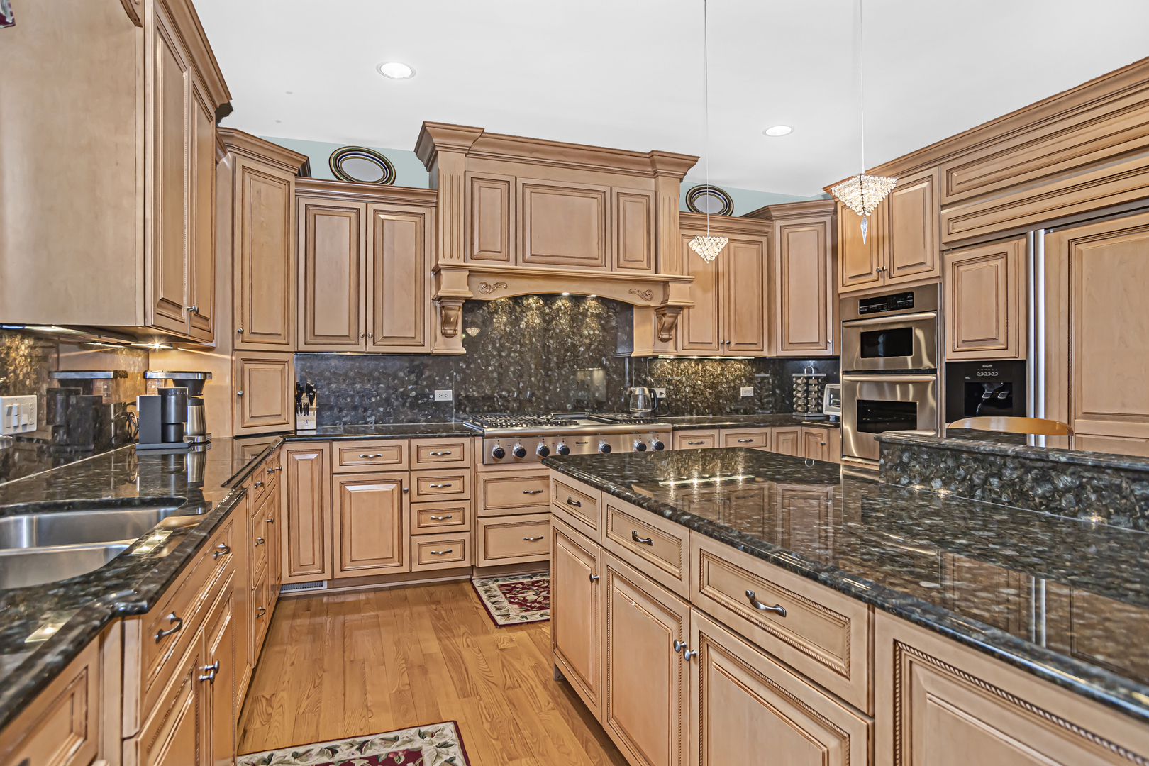 8040 West Charmaine Road Norridge, IL 60706 - Photo 18 of 62 a kitchen with stainless steel appliances granite countertop a sink stove and cabinets