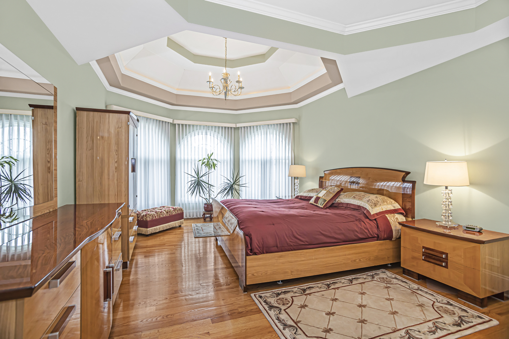 8040 West Charmaine Road Norridge, IL 60706 - Photo 26 of 62 a bedroom with a bed and a chandelier