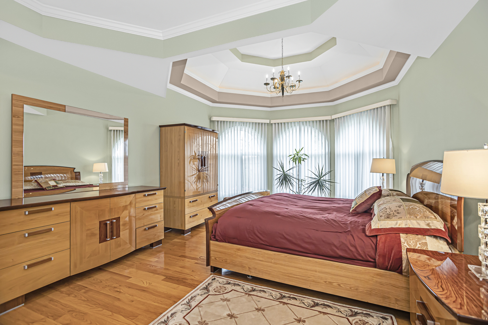 8040 West Charmaine Road Norridge, IL 60706 - Photo 27 of 62 a bedroom with a large bed and a chandelier