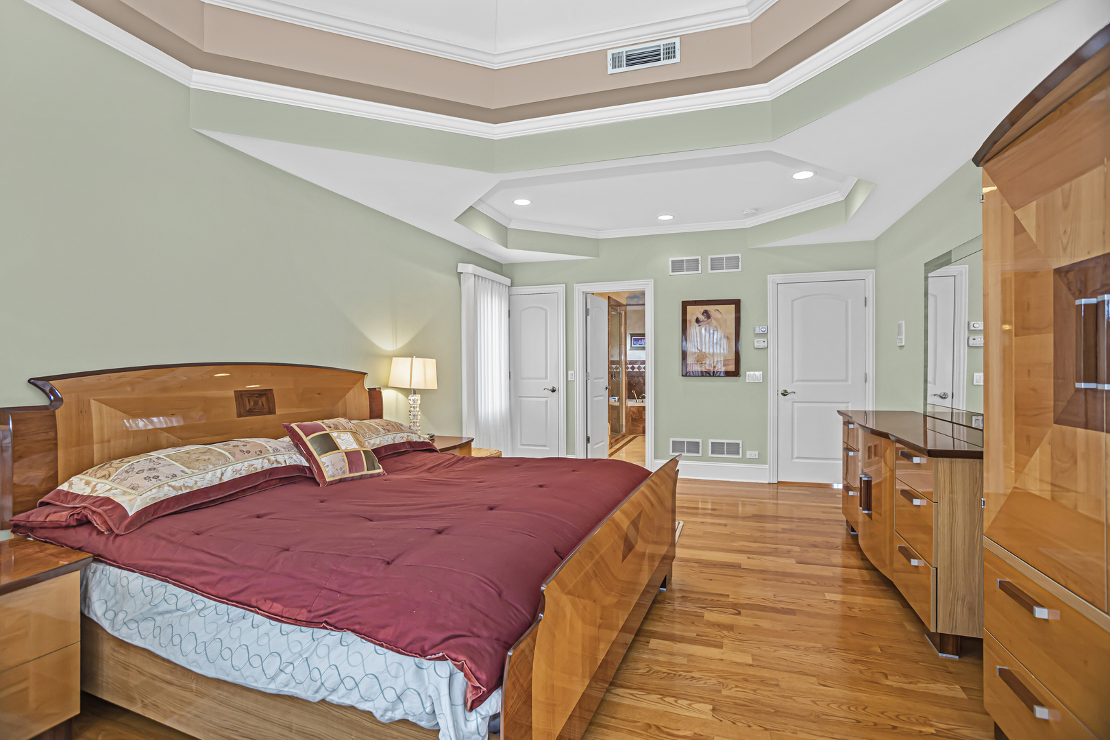 8040 West Charmaine Road Norridge, IL 60706 - Photo 28 of 62 a bedroom with a large bed and wooden floor