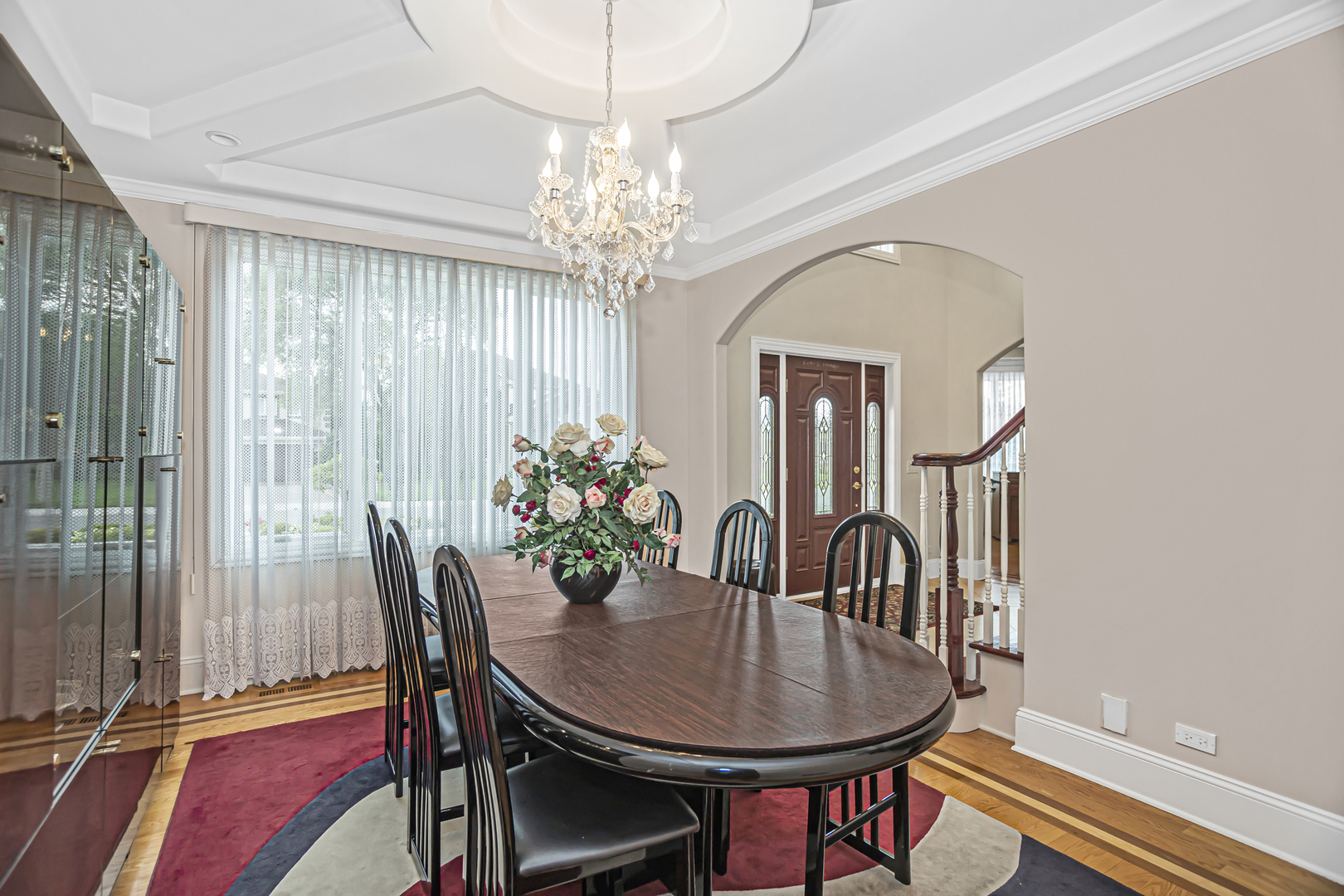 8040 West Charmaine Road Norridge, IL 60706 - Photo 7 of 62 a dining room with furniture a chandelier and wooden floor