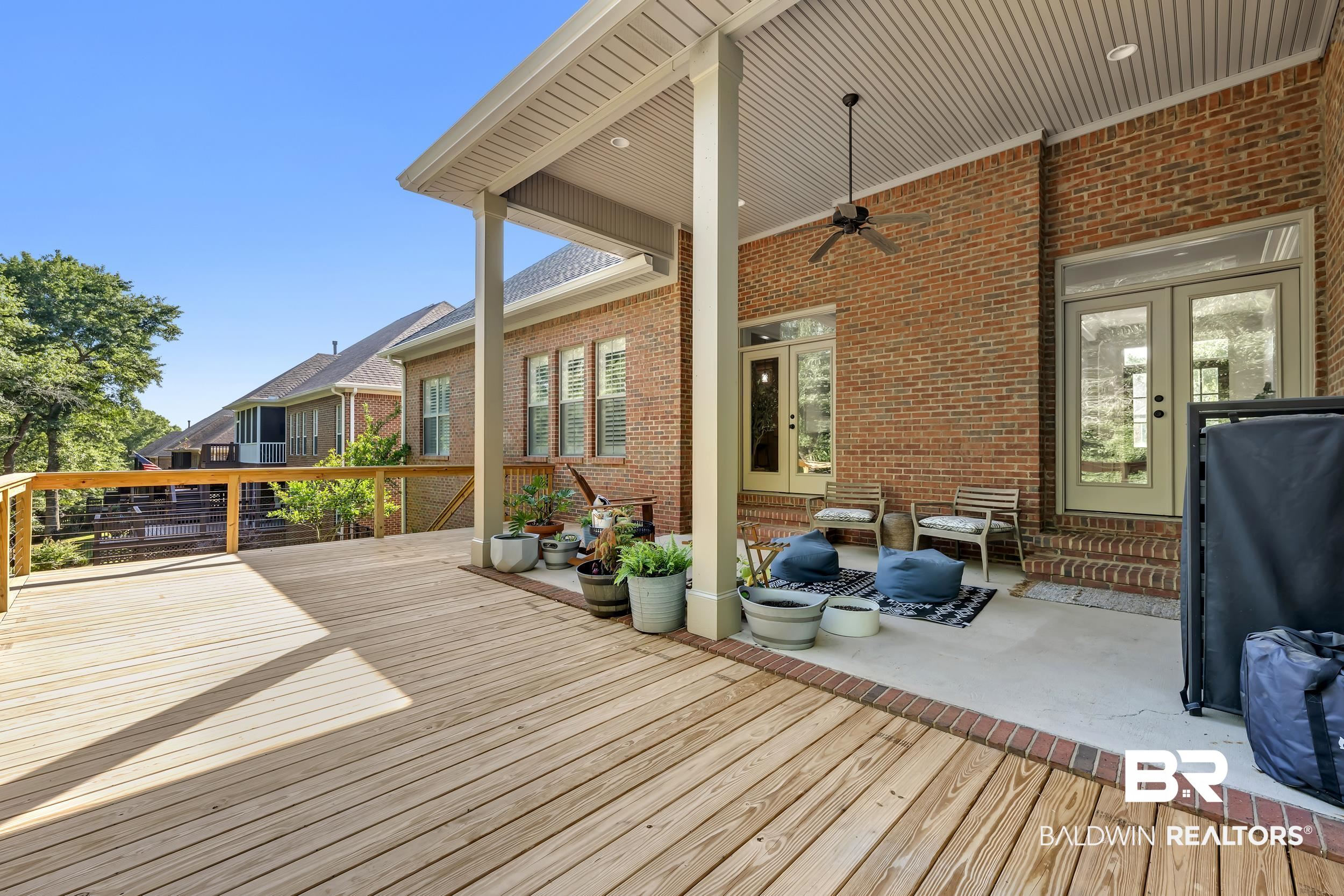8137 Pine Run Daphne, AL 36527 - Photo 44 of 67 Expansive rear deck and covered patio featuring wood-finish flooring, brick exterior, ceiling fan, recessed lighting, and double-door entry points