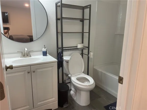 a white toilet sitting next to a bathroom sink