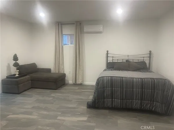 a bedroom with a bed and a couch