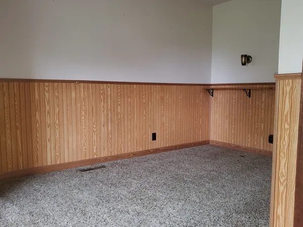 an empty room with a wooden door