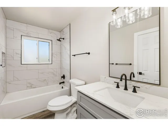 a bathroom with a sink toilet a mirror and shower