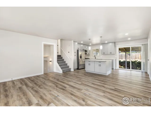 a view of a kitchen with wooden floor