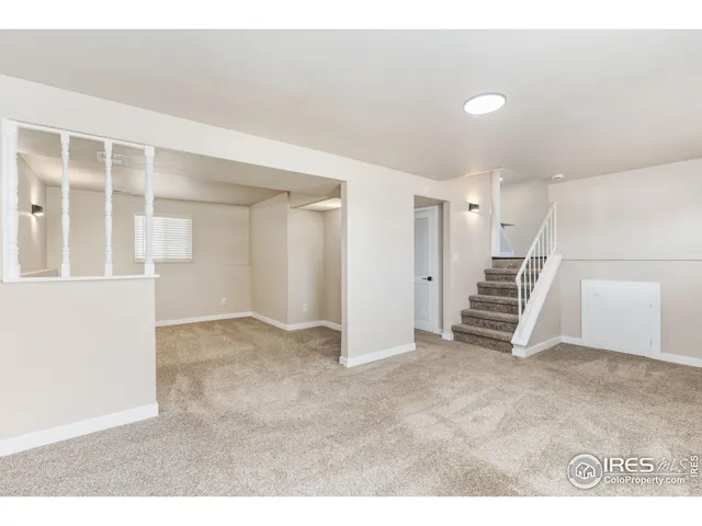 a view of an empty room with stairs
