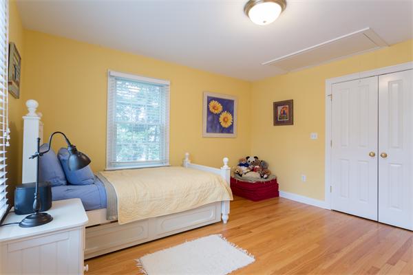 34 Bellflower Street Lexington, MA 02421 - Photo 17 of 21 a bedroom with a bed and wooden floor