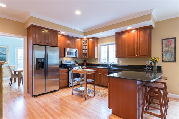 34 Bellflower Street Lexington, MA 02421 - Photo 6 of 21 a kitchen with stainless steel appliances granite countertop sink stove refrigerator and wooden floor