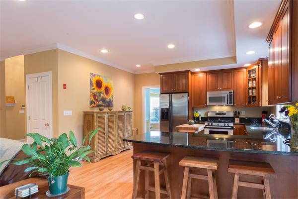 34 Bellflower Street Lexington, MA 02421 - Photo 7 of 21 a kitchen with counter top space and living room view