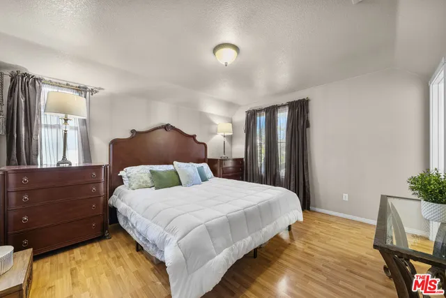 a bedroom with a bed and a potted plant