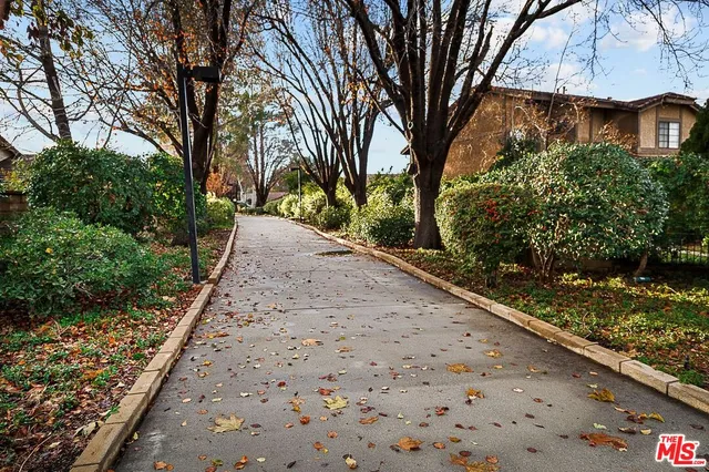 a view of a pathway both side of house