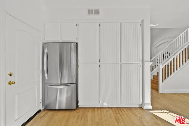 a view of a kitchen with wooden floor and staircase
