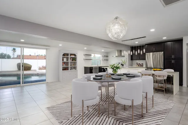 a view of open kitchen with stainless steel appliances a refrigerator and a stove top oven