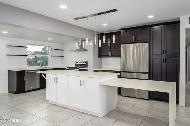 an empty room with fireplace and chandelier