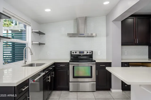 a living room with furniture a fireplace and a chandelier