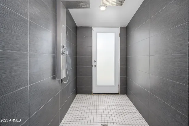 an empty room with window and ceiling fan