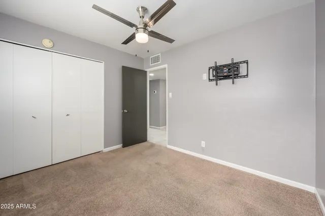 a view of a big room with closet and windows