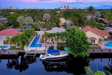 an aerial view of a house with garden space and street view
