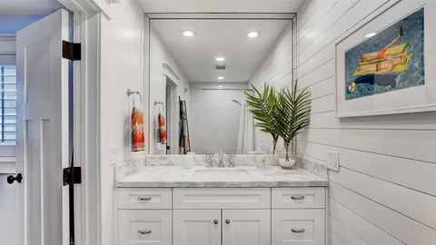 a view of a patio with couple of furniture and garden