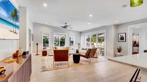 a view of a patio with table and chairs and potted plants with wooden floor and fence