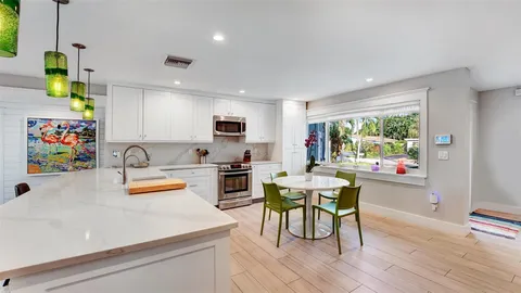 a couple of palm trees sitting in front of a house