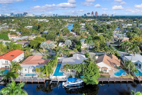 an aerial view of residential houses with outdoor space and swimming pool
