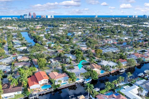 an aerial view of residential houses with outdoor space and swimming pool