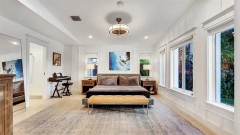 a living room with furniture gym equipment and a large window