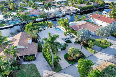 a aerial view of a house with a yard and potted plants