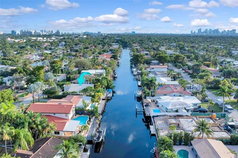 an aerial view of a house with a yard basket ball court and a fountain