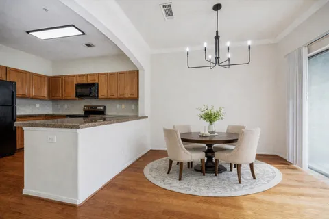 a view of a kitchen with a table and chairs