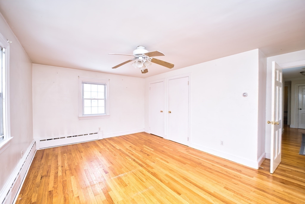 247 Albany Street Fall River, MA 02720 - Photo 12 of 37 a view of a room with wooden floor and ceiling fan