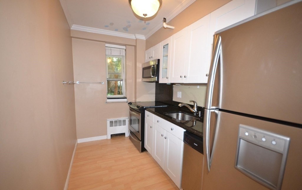 145 Pinckney Street, Unit 135 Boston, MA 02114 - Photo 7 of 7 a kitchen with stainless steel appliances granite countertop a stove a sink and a refrigerator