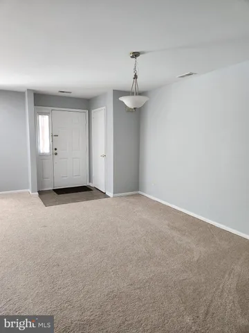 a view of empty room with a fan