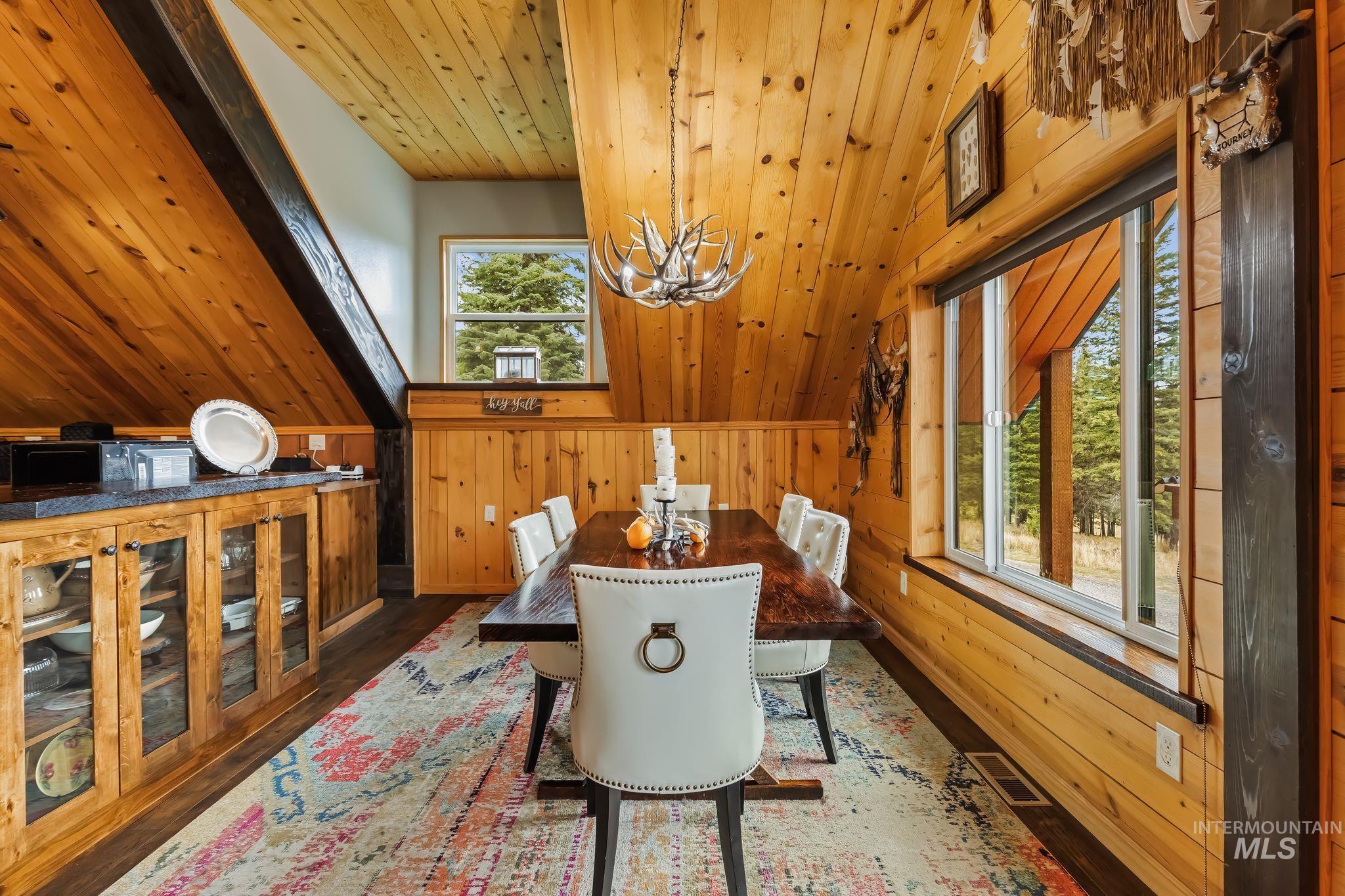 3989 East Mountain Road Anatone, WA 99401 - Photo 12 of 49 Vaulted wood-paneled ceiling, wood-finish flooring, built-in wood cabinetry with glass fronts, and dual windows